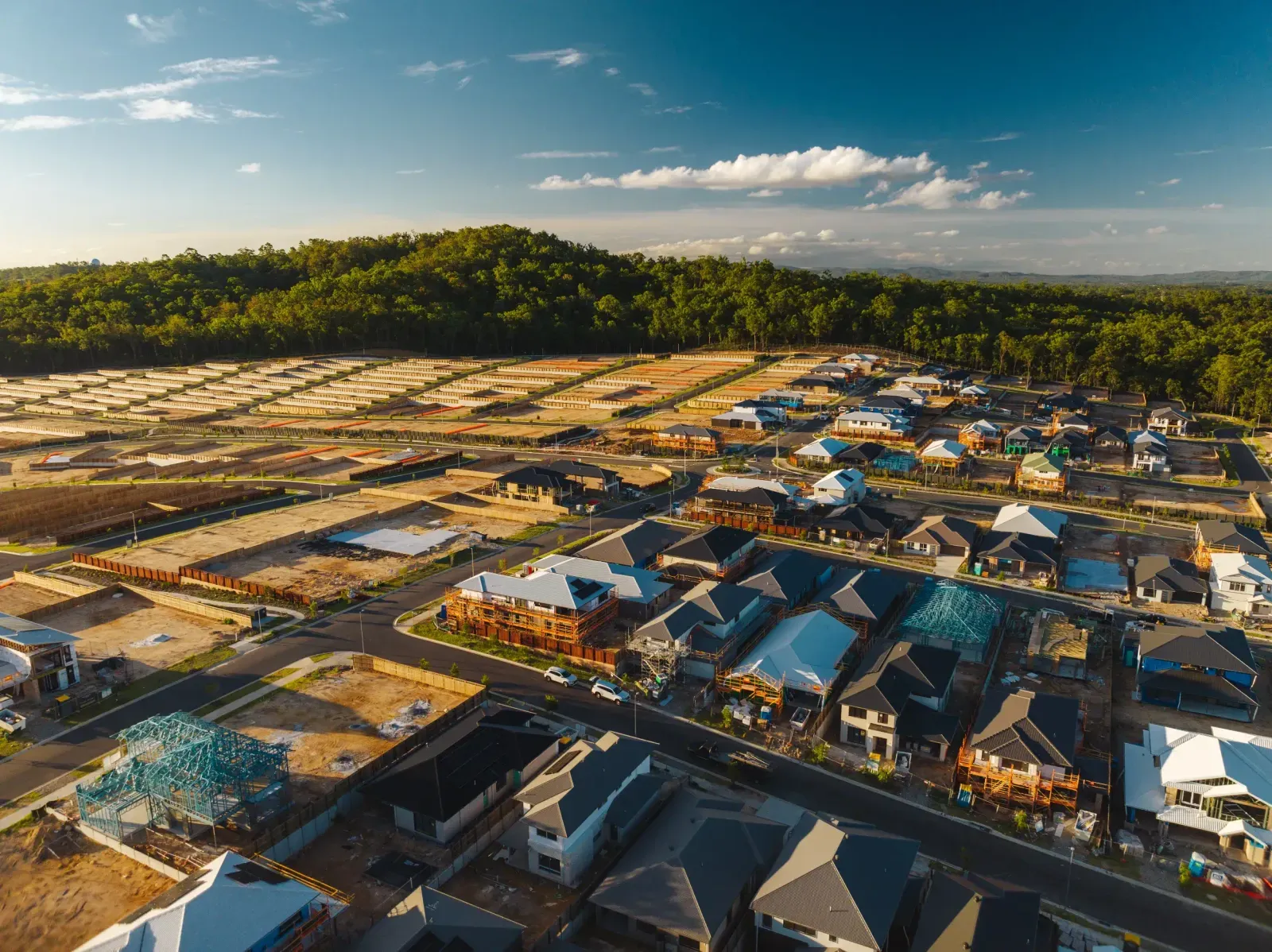 Aerial view of new-build homes with solar installation in progress